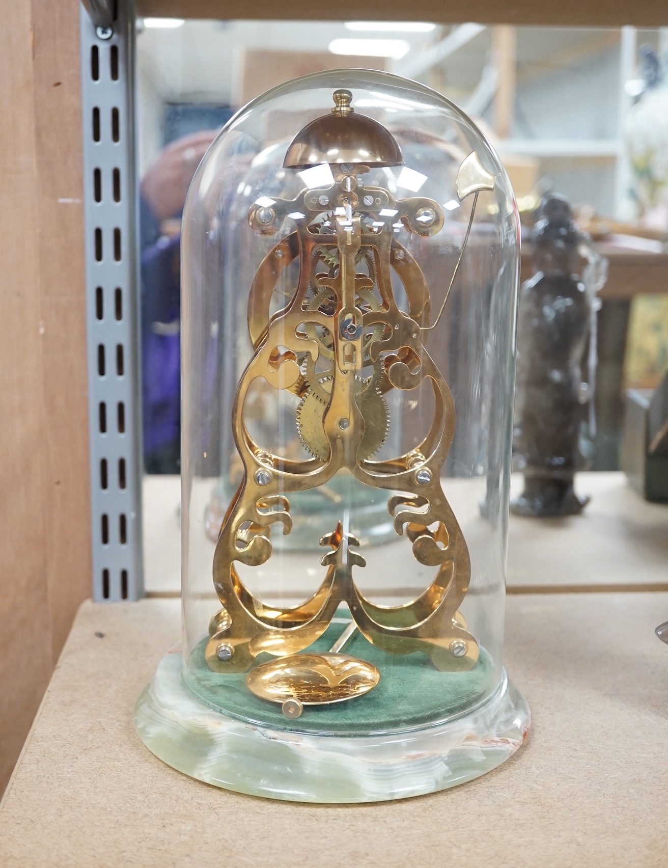 A Thwaites & Reed brass skeleton clock under dome, on onyx base, 27cm. Condition - good, not tested